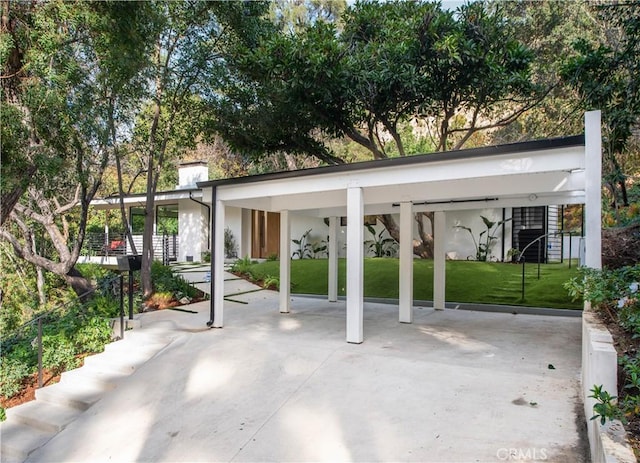 view of parking featuring a carport and a lawn