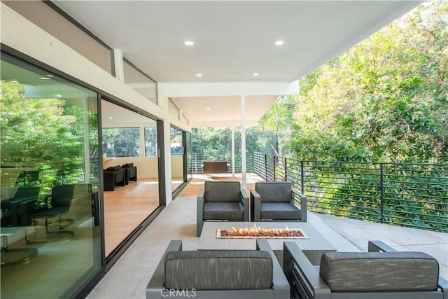 view of patio featuring an outdoor living space with a fire pit