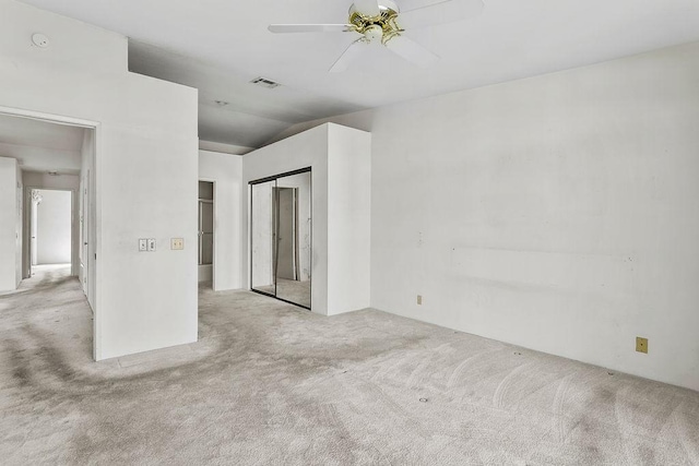 unfurnished room featuring light colored carpet and ceiling fan