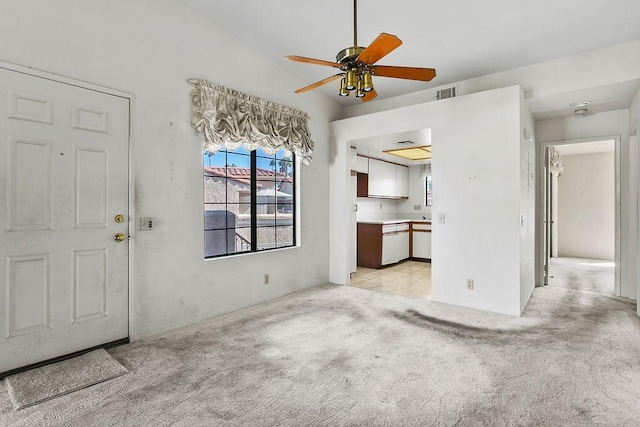 unfurnished living room featuring light carpet and ceiling fan