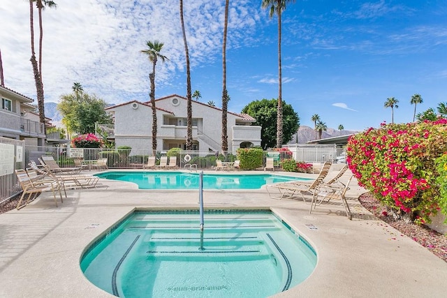 view of pool featuring a patio and a community hot tub