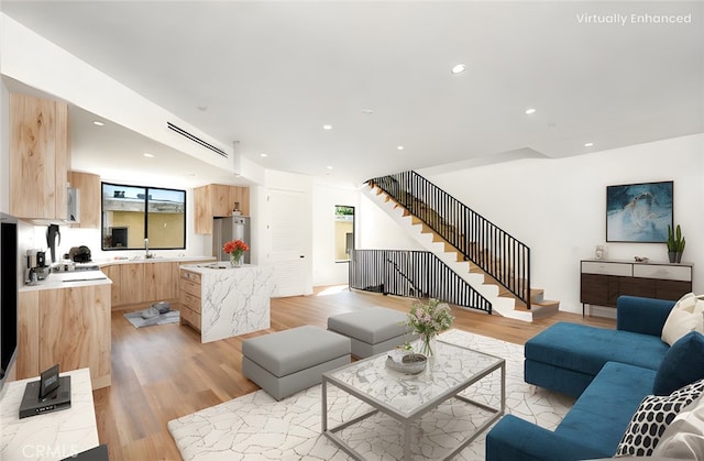 living room featuring sink and light wood-type flooring