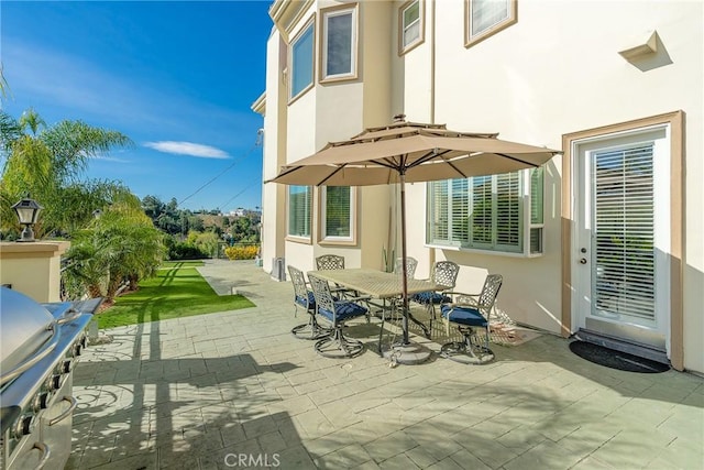 view of patio featuring outdoor dining space and grilling area