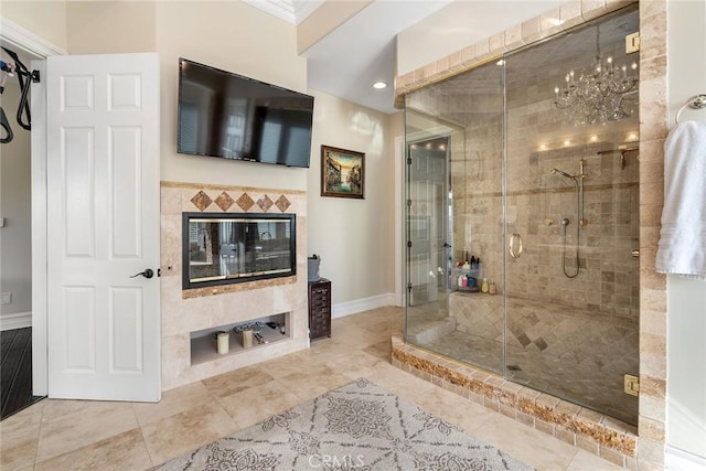 bathroom featuring ornamental molding, baseboards, recessed lighting, a chandelier, and a stall shower