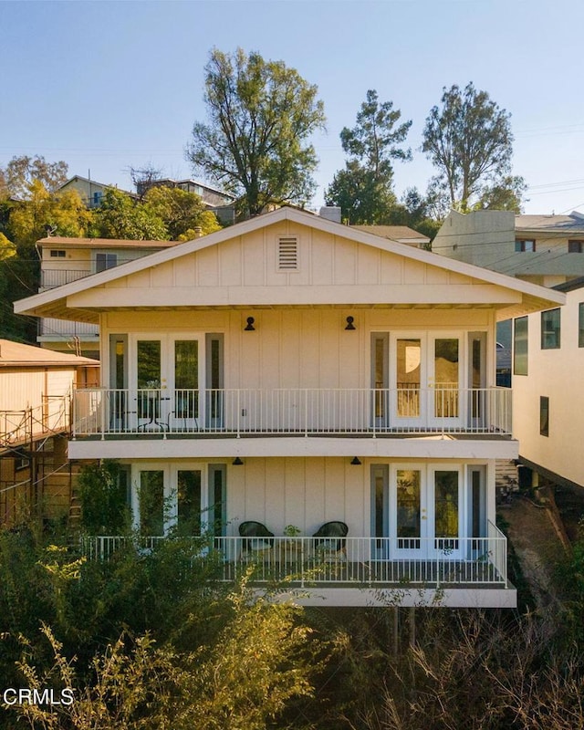 rear view of house with french doors and a balcony