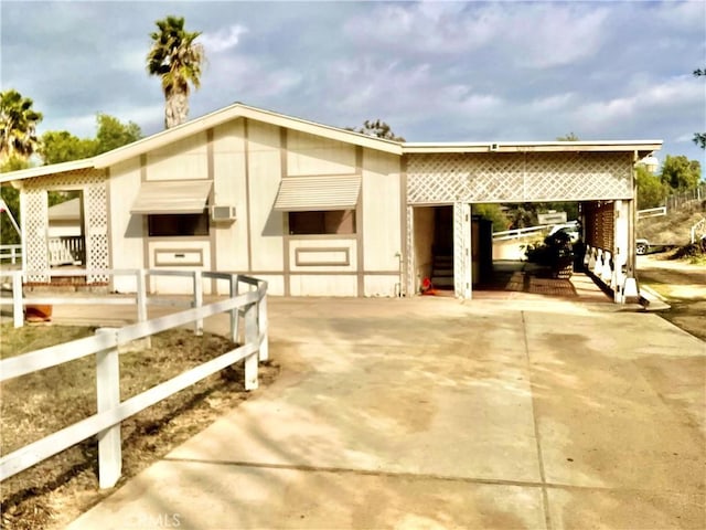 view of front of home featuring driveway and a carport