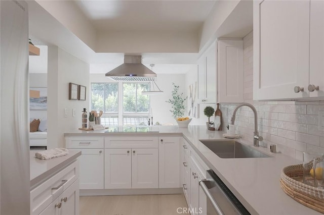 kitchen featuring black electric cooktop, island exhaust hood, sink, and white cabinets