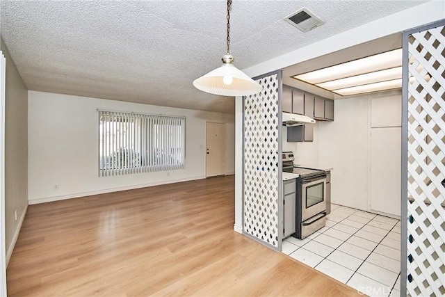 kitchen with light hardwood / wood-style flooring, electric stove, and a textured ceiling