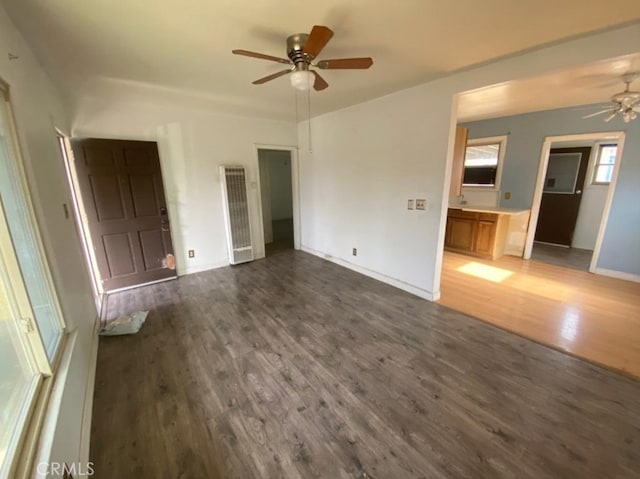 unfurnished bedroom featuring ceiling fan and dark hardwood / wood-style floors