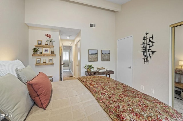 bedroom featuring high vaulted ceiling and beamed ceiling