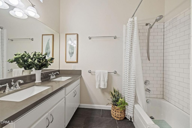 bathroom with shower / bath combo, tile patterned floors, and vanity