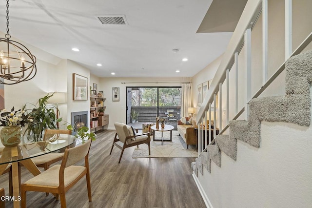 living room featuring wood-type flooring and a notable chandelier