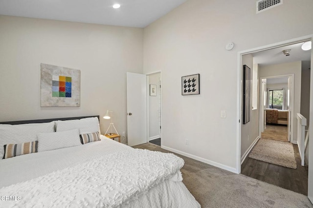 carpeted bedroom featuring high vaulted ceiling