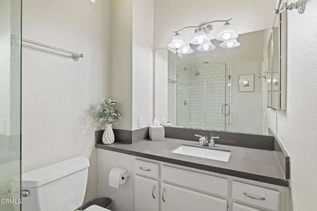 bathroom with vanity, toilet, and walk in shower