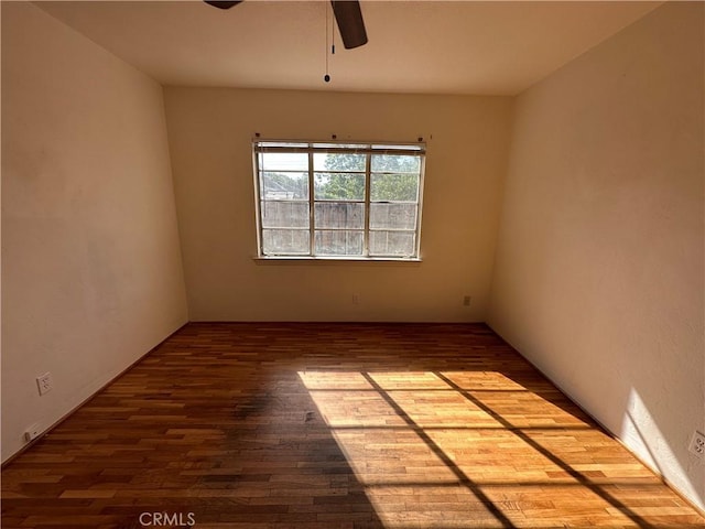 empty room with wood-type flooring and ceiling fan