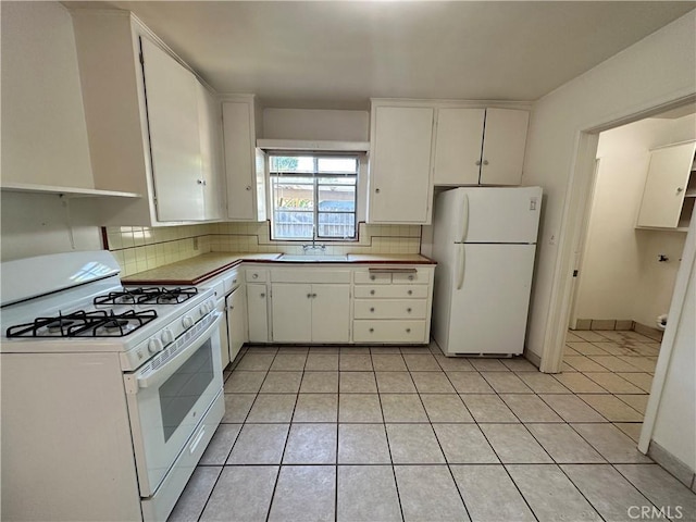 kitchen with white cabinetry, white appliances, sink, and decorative backsplash