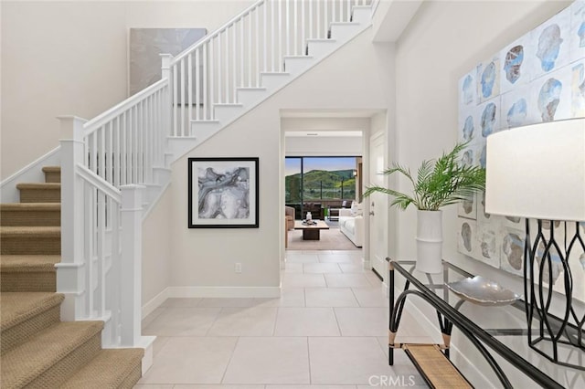 tiled entrance foyer with a high ceiling