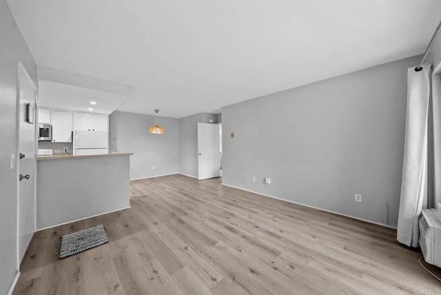 unfurnished living room featuring light hardwood / wood-style floors