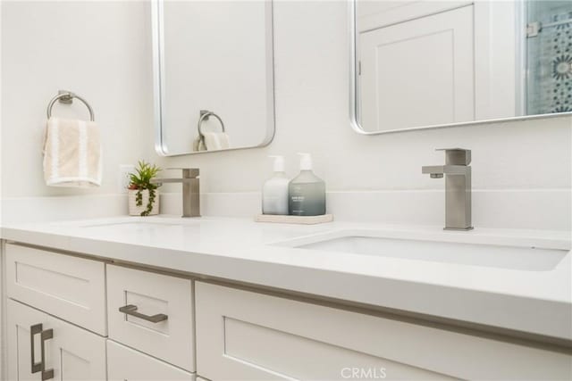 bathroom featuring a sink and double vanity