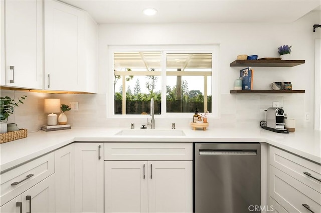 kitchen featuring white cabinetry, dishwasher, and a sink