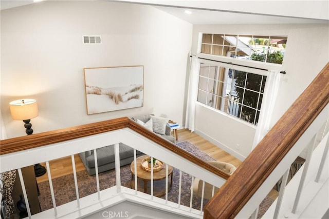 stairway with recessed lighting, visible vents, and wood finished floors