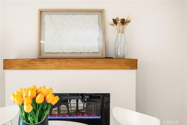 interior details featuring a glass covered fireplace