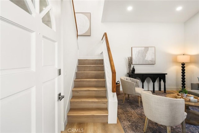 staircase featuring wood finished floors and recessed lighting