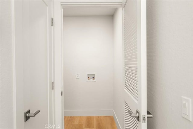 washroom with laundry area, washer hookup, light wood-type flooring, and baseboards