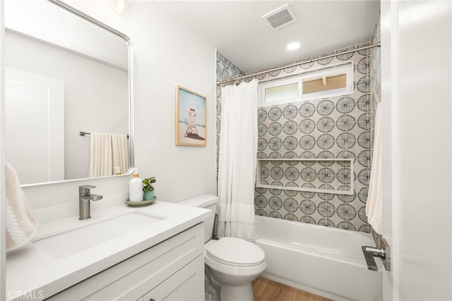 full bathroom with toilet, vanity, shower / bath combination with curtain, and visible vents