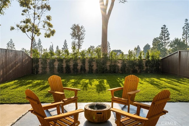 view of patio with a fenced backyard and a fire pit