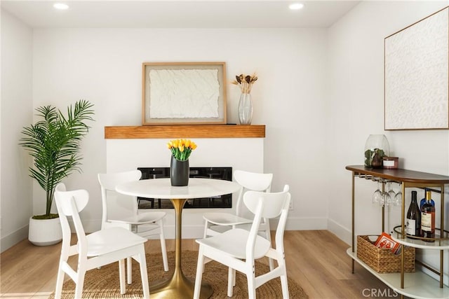 dining space with recessed lighting, wood finished floors, and baseboards