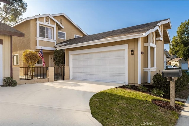 traditional-style house featuring concrete driveway, roof with shingles, and an attached garage