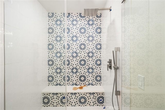 full bath featuring tiled shower