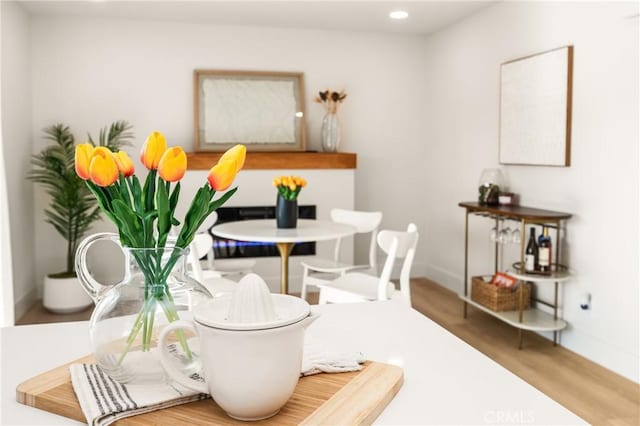 dining room with baseboards, wood finished floors, and recessed lighting