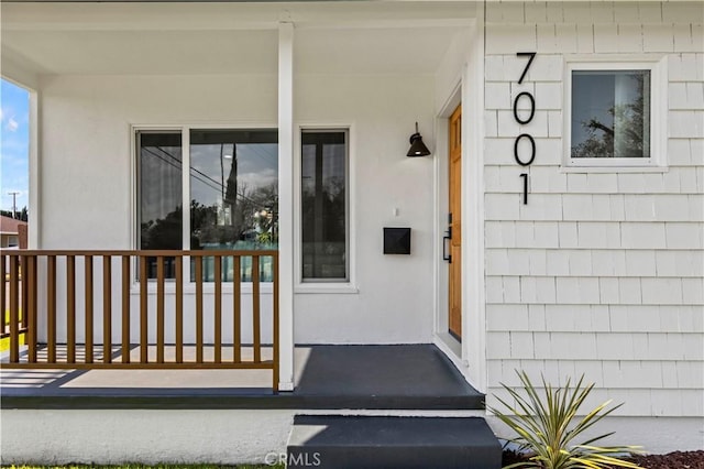 view of exterior entry with a porch