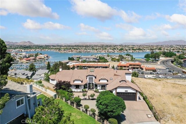 birds eye view of property with a water and mountain view