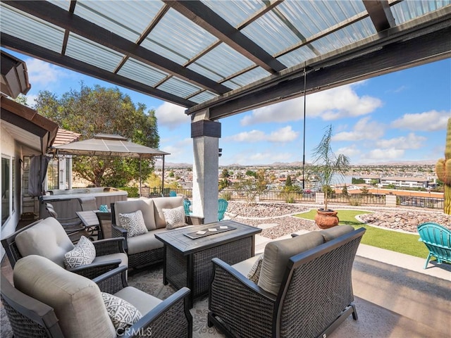 view of patio / terrace featuring outdoor lounge area, fence, a hot tub, and a pergola