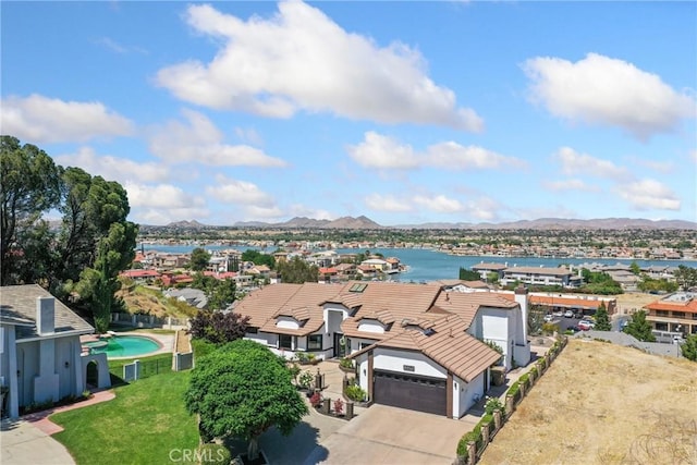 aerial view featuring a water and mountain view