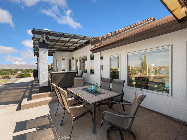 view of patio with outdoor dining space and a mountain view