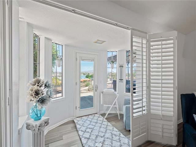 entryway featuring wood finished floors and baseboards