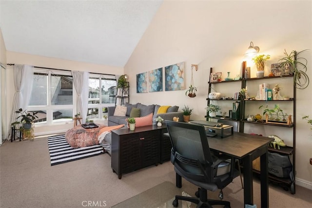 office area with high vaulted ceiling and light carpet