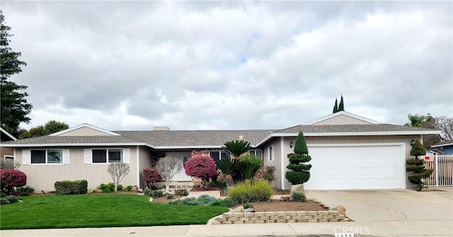 ranch-style house with a chimney, concrete driveway, a front yard, fence, and a garage