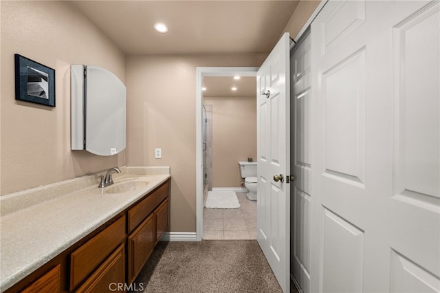 bathroom featuring vanity, tile patterned flooring, and toilet