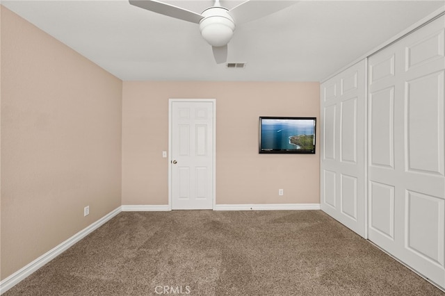 unfurnished bedroom featuring ceiling fan and carpet flooring