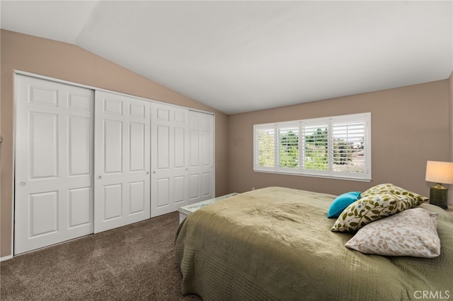 carpeted bedroom featuring vaulted ceiling and a closet