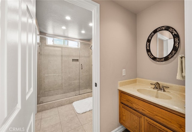 bathroom with tile patterned flooring, vanity, and an enclosed shower