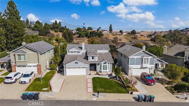 birds eye view of property with a mountain view