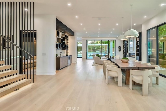 dining room featuring sink and light hardwood / wood-style floors