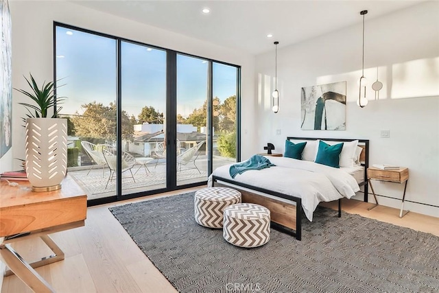 bedroom with access to exterior and light wood-type flooring