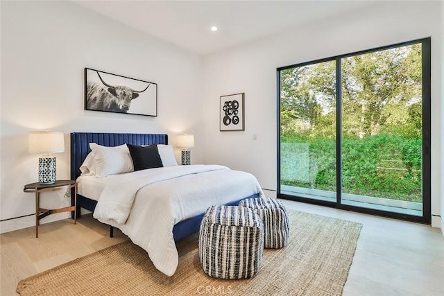 bedroom with hardwood / wood-style flooring and access to exterior